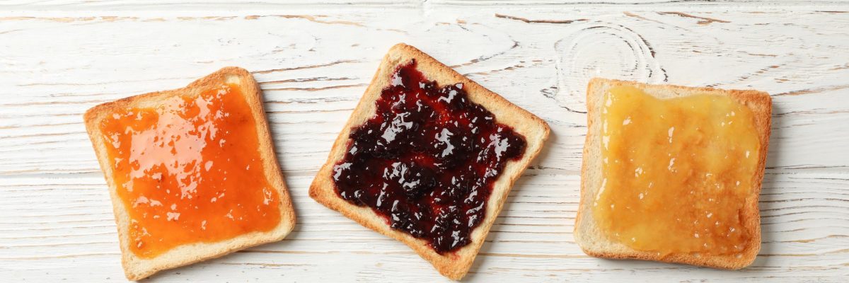 toasts-with-delicious-jams-on-wood-top-view